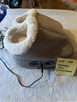 Heated foot massager with soft, plush white interior and fabric grey exterior, showing the foot openings and general shape