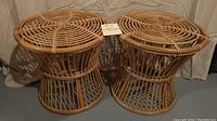 Two round bamboo rattan stools side by side showing top pattern and base structure