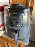 Front view of Ninja air fryer showing digital control panel and handle