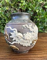 Side view of the vintage Asian dragonware stone pot urn showing detailed raised dragon designs and coloration.