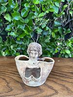 Vintage handmade ceramic bust planter pot shown from the front, highlighting detailed facial features and hollow hands.