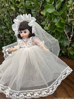 Front view of vintage Madame Alexander bride doll outdoors showing full bridal gown and veil