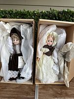 Two Marjorie Spangler dolls shown in their original boxes, wrapped in white tissue paper.