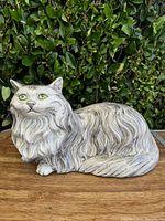 Front view of the vintage gray ceramic Persian cat figurine showing detailed fur texture and green eyes.