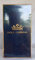 Blue Dolce & Gabbana outer box with gold crown logo and brand name on front.