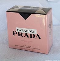 Photo of closed and sealed pink and black Prada Paradoxe perfume box, new in original packaging.