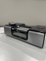 Close-up photo of the Sony alarm clock radio showing its front digital display, speakers, and top controls.