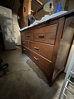 Three-quarter front view showing overall dresser shape, finish, and drawer arrangement.