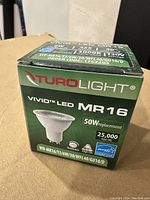 Box of TuroLight Vivid LED MR16 bulb, 50W replacement, showing product details including 25,000 hour life and 3000K color temperature.