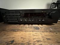 Front view showing control buttons, knobs, and tuner display of Nakamichi RE-1 stereo receiver