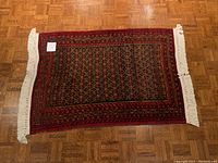 Full view of the antique Afghan wool rug showing size, shape, and design.