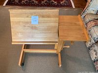 Front angled view showing the adjustable tilt top raised and caster wheels on base.