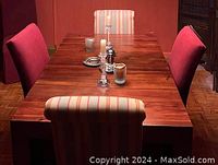 Dining table with chairs shown for scale