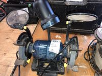 Full view of Mastercraft 6 inch bench grinder showing main unit, wheels, eye shields and tool rests