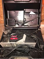 Freud FE82 electric planer in a molded black plastic carrying case, showing top view with model label and power cord.