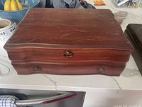 Closed wooden case top view showing surface scratches