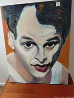 Front view of the portrait painting showing the male singer with a focused expression and colorful brush strokes.