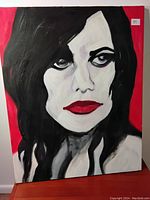 Front view of the acrylic portrait painting featuring a female singer with dark hair and red lips on red background, showing sticker number 31.