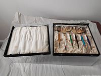 Set of 6 enamel-handled forks in their original presentation box with satin fabric lining.