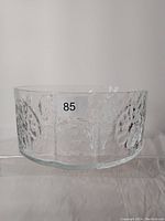Side view showing clear glass and detailed floral embossed design on the bowl.