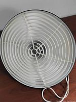 Top view of the inside of the lamp shade showing a white plastic diffuser with concentric ridges for light diffusion.