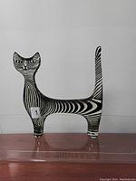 Front view showing stylized cat form and stripe pattern