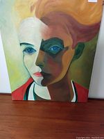 Front view of the colourful abstract portrait painting showing details of face and hair colors