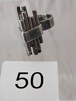 Close-up side view of the sterling silver ring showcasing the geometric cylindrical bars design and band width.