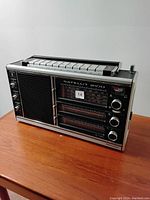 Side angle view showing the front speaker, tuning dials and push button preset controls on top.