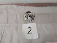 Top down view of the sterling silver ring showing the large central stone and two smaller side stones.