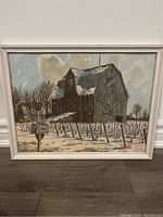 Front view of framed watercolour and ink painting depicting a barn and vineyard in winter with snow and bare trees.
