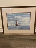 Framed lighthouse print by Donald Voorhees showing the entire artwork, mat, and frame.