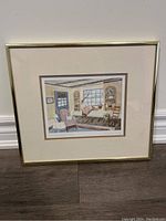 Full view of the framed print showing interior scene with woman sitting on window sill