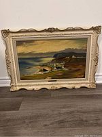 Full view of the framed oil painting depicting Hilton Village landscape with ocean and cliffs.