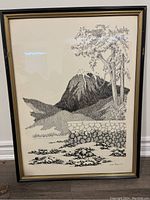Full view of the framed black and white mountain drawing, showing stone wall, tree, and mountain landscape.