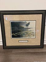 Framed Robert Bateman print showing moose near pond with lily pads.
