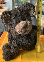 Boyds Black Bear Statue Baxter side view with height tape measure showing approximately 10 inches tall