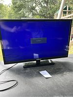 Front view of 32 inch Element television powered on with 'No Signal' message on screen. TV has black frame and connected power cord.