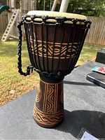 Side view of the African djembe drum showing carved wooden body and rope tuning system