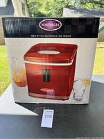 Front view of Nostalgia brand ice maker box showing red unit image, brand name, and product type '50s-Style Automatic Ice Maker.