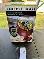 Box front showing product image and highlighting built-in sensor for motion activation dispensing candy.