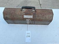 Closed rusty Craftsman metal toolbox with black handle and metal latch