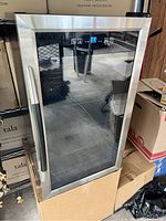 Front view of stainless steel beverage cooler showing glass door and digital control panel