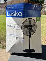 Box showing Lasko branding, product image and features like oscillating large room pedestal fan with remote control and 4-speed comfort control.