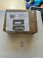 Photo of the box showing the front with label containing product name and instructions.