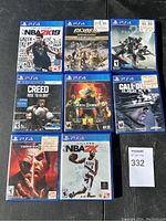 Photo showing 8 PlayStation 4 game cases arranged in 3 rows including NBA 2K19, G.I. Joe Operation Blackout Gold Edition, Destiny 2, Creed Rise to Glory (PSVR), Mortal Kombat 11 Aftermath, Call of Duty Ghosts, Tekken 7, NBA 2K21