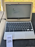 Front view of Samsung laptop open with screen on, displaying 'No Internet' message, keyboard and charger cable connected.