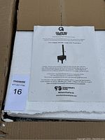 Top view showing instruction manual laid on white foam padding in the shipping box.