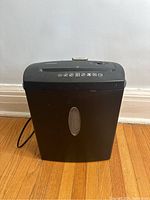 Front view of black Staples paper shredder showing overall condition and control panel on top