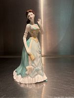 Front view of Royal Doulton Gillian figurine dressed in pale green, standing approximately 8.5 inches tall